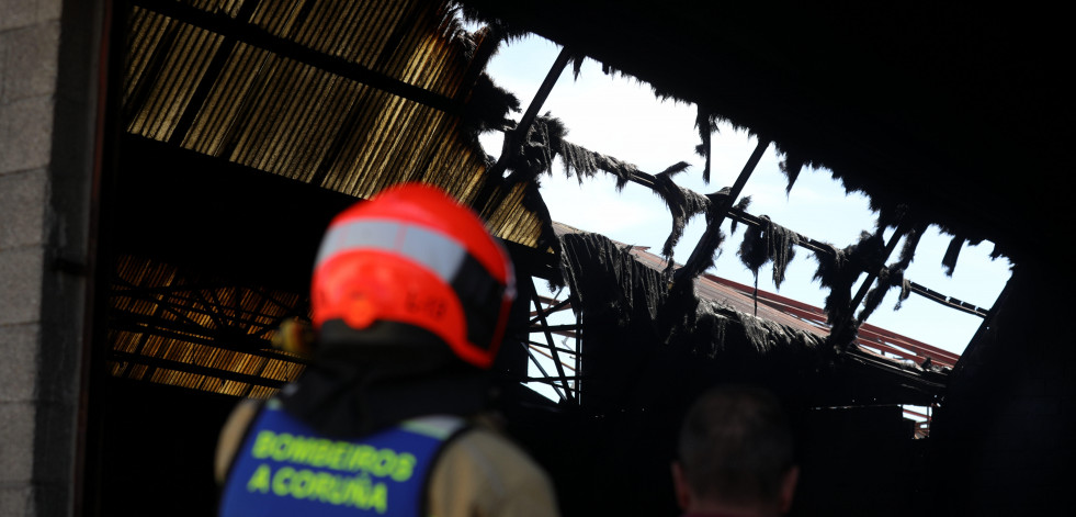 Los bomberos extinguen un tejado en llamas en una nave industrial de A Grela