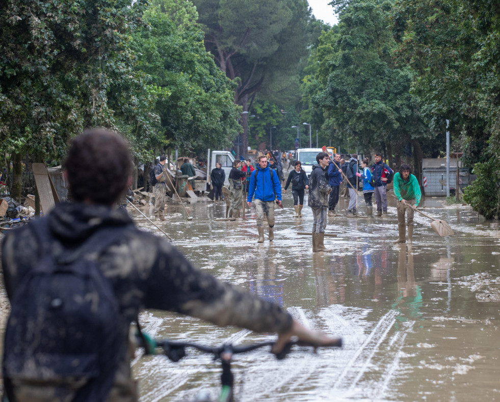 EuropaPress 5212471 may 19 2023 faenza italia people walk as they clean flooded street following 13514550
