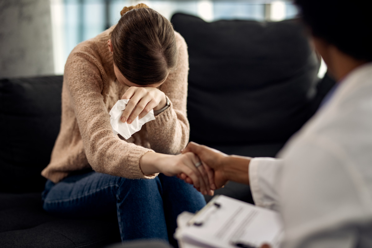 Depressed woman seeking solace from her psychotherapist