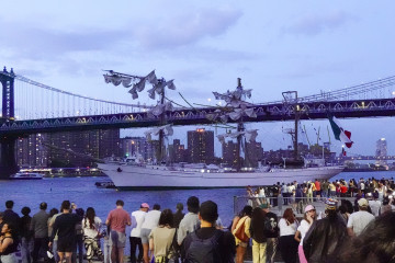 NEW YORK (United States), 18/05/2025.- People look at the Cuauhtemoc, a Mexican Navy training boat, as it sits in the East River after the ship hit the Brooklyn Bridge, in New York, New York, USA, 17 